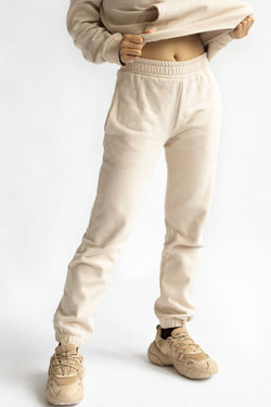 shop almond latte loose pants by capsule studio at thegreenlabels